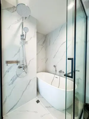 a bathroom with a tub and a glass shower at New Modern 1Bdr Laya 500 m to the Beach in Layan Beach