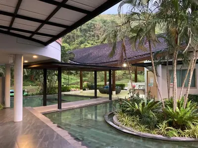 an image of a house with a swimming pool at Spacious studio with access to the pool in Karon Hill condo in Karon Beach