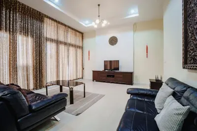 a living room with a couch and a table at Number Nine Pool Villa in Ban Tha Rua