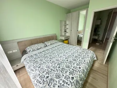 a bedroom with a bed with a black and white comforter at The Base Height in Phuket Town
