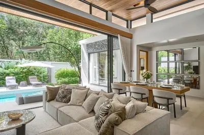 an open living room with a couch and a table at Premium Villa Botanica 3-BR with Pool and Garden in Ban Pak Lak