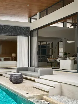 a living room with a swimming pool and a house at Premium Villa Botanica 3-BR with Pool and Garden in Ban Pak Lak