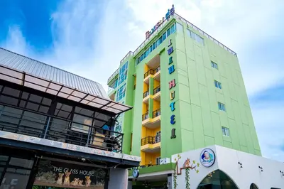 a tall green building with a sign on it at Lulu Hotel at The Glasshouse Lion Café in Ban Sire