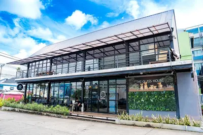 a store front of a building with a lot of windows at Lulu Hotel at The Glasshouse Lion Café in Ban Sire