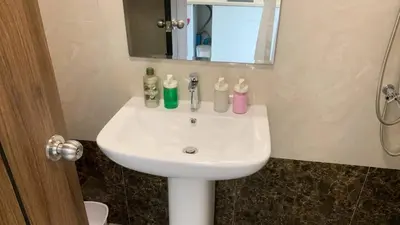 a white sink in a bathroom with a mirror at Cozy studio Sunset view near of MaiKhao beach in Ban Mai Salae