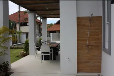 a patio with a table and chairs in a house at Villa with private pool in Kamala in Kamala Beach