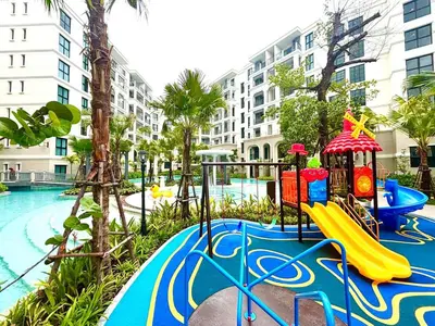 a playground with a slide next to a pool at The Legendary Apartment 408 in Bang Tao Beach
