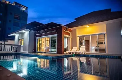 a swimming pool in front of a house at ZJ Garden Pool Villa in Phuket Town