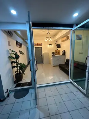 an open door to a room with a kitchen at LimeTree Loft Guesthouse in Patong Beach