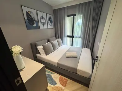 a small bedroom with a bed and a window at The Legendary Apartment 209 in Bang Tao Beach