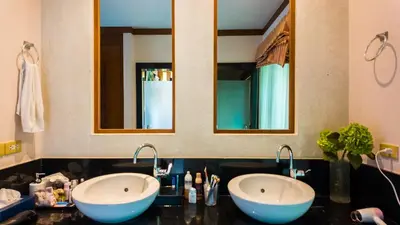 two sinks in a bathroom with two mirrors at Genesis Elephant Villa in Rawai Beach