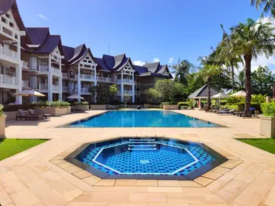 a swimming pool in front of a villa at Apartment 2 bedrooms in Allamanda in Laguna Phuket