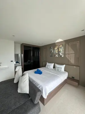 a bedroom with a large bed with a blue towel on it at The Viva Patong Sea view and Mountain views in Patong Beach