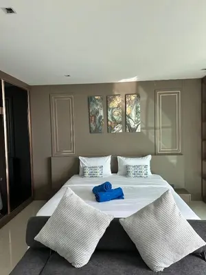 a large white bed with a blue towel on it at The Viva Patong Sea view and Mountain views in Patong Beach