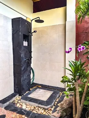 a shower in a bathroom with a black shower door at OASIS by Four Twenty in Chalong