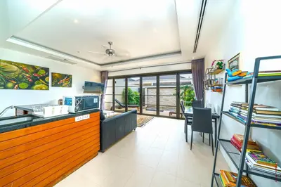 a kitchen with a counter and a table with chairs at The Residence One-Bedroom Villa in Ban Thalat Choeng Thale