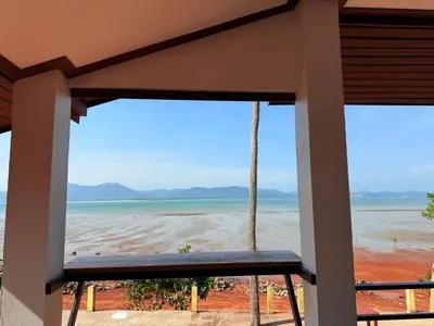 a view of the beach from the porch of a beach house at The Good View Koh Yao Noi in Ko Yao Noi