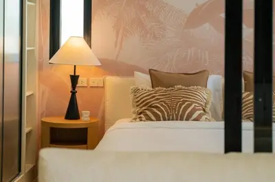 a bedroom with a bed and a lamp on a table at Modern 1BR with Pool View The Title Legendary in Bang Tao Beach