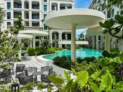 an exterior view of a building with a swimming pool at Modern 1BR with Pool View The Title Legendary in Bang Tao Beach
