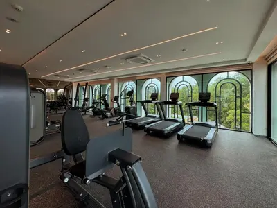 a gym with a lot of treadmills and ellipticals at Modern 1BR with Pool View The Title Legendary in Bang Tao Beach