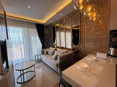 a living room with a couch and a table at New Studio in Bellevue Lagoon Phuket in Laguna Phuket