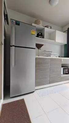 a kitchen with a white refrigerator in a room at The Azure Kathu in Kathu