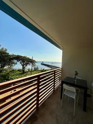 a balcony with a table and a view of the ocean at Apartment with sea view 2 beds in Kamala Beach