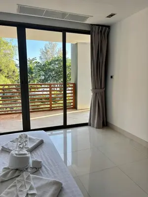 a room with a bed with a view of a balcony at Apartment with sea view 2 beds in Kamala Beach