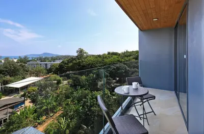 a balcony with a table and chairs and a view at Stylish apartments in Calypso Garden condo, Sea View! in Rawai Beach