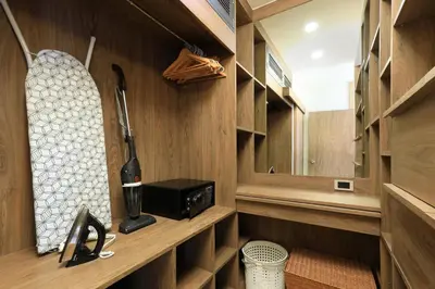 a bathroom with wooden cabinets and a sink and a mirror at Stylish apartments in Calypso Garden condo, Sea View! in Rawai Beach