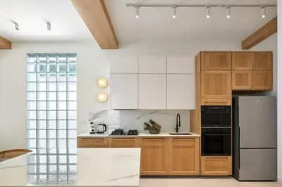 a kitchen with wooden cabinets and a stainless steel refrigerator at Villa Moana 2BR Private Pool Naiharn beach in Rawai Beach