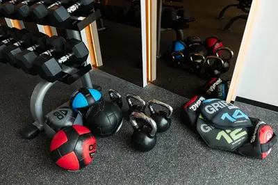 a pile of balls and dumbbells in front of a mirror at Cute apartment 52 m2 in Brand New condo! BangTao in Bang Tao Beach