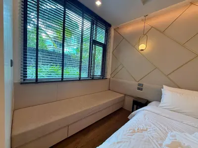 a small bedroom with a bed and a window at New Apartment on the 1floor in The Proud Karon in Karon Beach