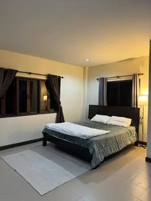 a bedroom with a bed and a window at Kamala Charming Local House near Kamala Beach in Kamala Beach