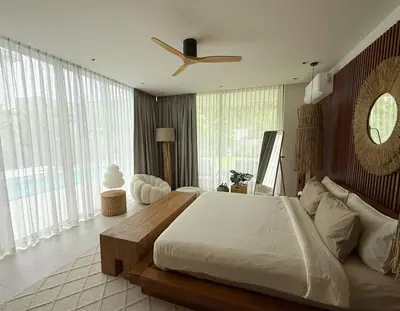a bedroom with a large bed and a ceiling fan at Lake View Landscape Modern villa Bang Tao in Ban Thalat Choeng Thale