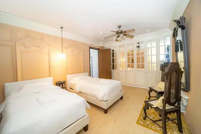 a bedroom with two beds and a television in it at Black Pearl 8 Bedroom Beach Villa Private Pool Gym Free Car Free Water and Electricity Maid 10 Meters to the Beach in Mai Khao Beach