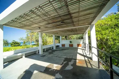 an empty porch of a house with a wooden ceiling at Black Pearl 8 Bedroom Beach Villa Private Pool Gym Free Car Free Water and Electricity Maid 10 Meters to the Beach in Mai Khao Beach