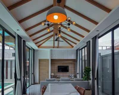 a dining room with a table and a ceiling with windows at Holiday Villa 2-BR J10, Private Pool, Rawai Beach in Phuket Town
