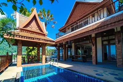 a resort with a swimming pool in front of a building at Patong Thai-style 4 Bedrooms Private Pool Sunset View Deck 6 Minutes to the Beach in Patong Beach