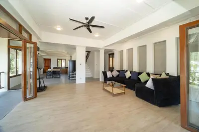 a living room with a couch and a ceiling fan at Patong Thai-style 4 Bedrooms Private Pool Sunset View Deck 6 Minutes to the Beach in Patong Beach