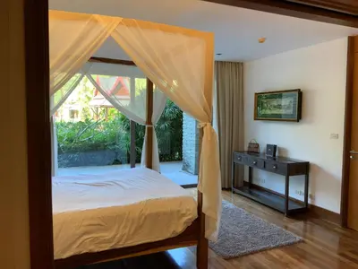a bedroom with a canopy bed with a window at Pearl of Nai Thon in Nai Thon Beach
