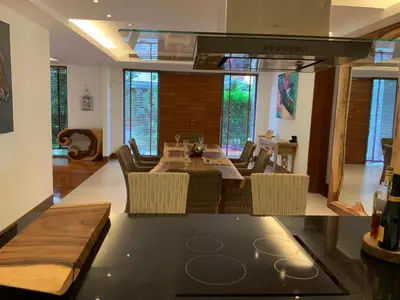 a kitchen and living room with a table and chairs at Pearl of Nai Thon in Nai Thon Beach