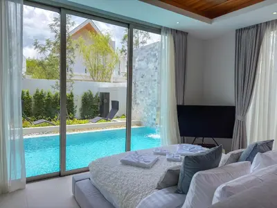 a living room with a bed and a pool at NEW! Luxury Pool Villa 4 Bedrooms in Lux Pride L27 Residence in Ban Pak Lak