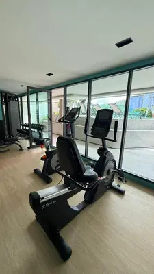 a gym with treadmills and ellipticals in a building at Space Cherngtalay Condo in bangtao by sahana in Bang Tao Beach