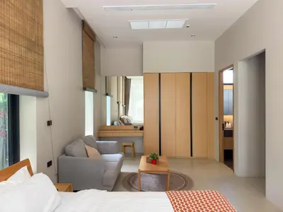 a bedroom with a bed and a couch and a chair at Luxury 3-Bedroom Pool Villa Long One B9 with Panoramic Chalong Bay View in Ban Bo Rae