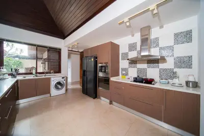 a kitchen with a black refrigerator and a dishwasher at Tropical Pool Villa Thai-modern Villa with an OFFICE in Phuket Town