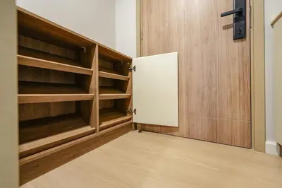 a closet with wooden shelves and a door at New condo near the sea, Laguna, Choeng Thale 324 in Ban Thalat Choeng Thale