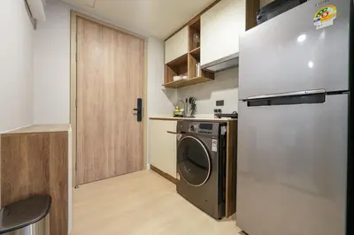 a kitchen with a washing machine and a refrigerator at New condo near the sea, Laguna, Choeng Thale 324 in Ban Thalat Choeng Thale