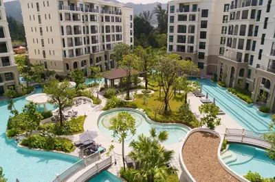an aerial view of a resort with two pools at The Title Legendary Elegant Suite Bangtao in Ban Thalat Choeng Thale