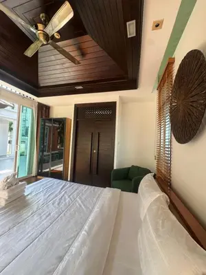a bedroom with a bed and a ceiling fan at Luxury Phuket Pool Villa in Ban Saiyuan (1)